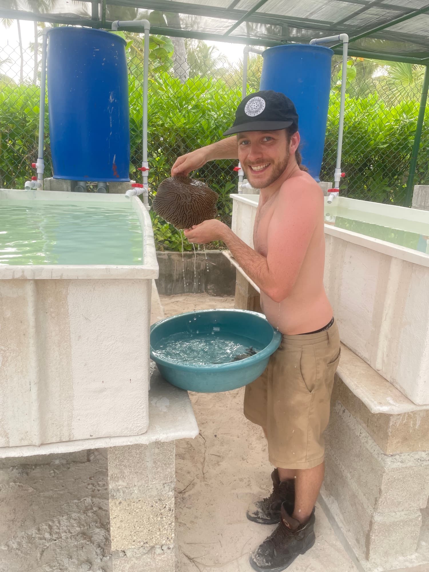 Max Ivers, founder of Coral Growth Solutions, holding a brain coral